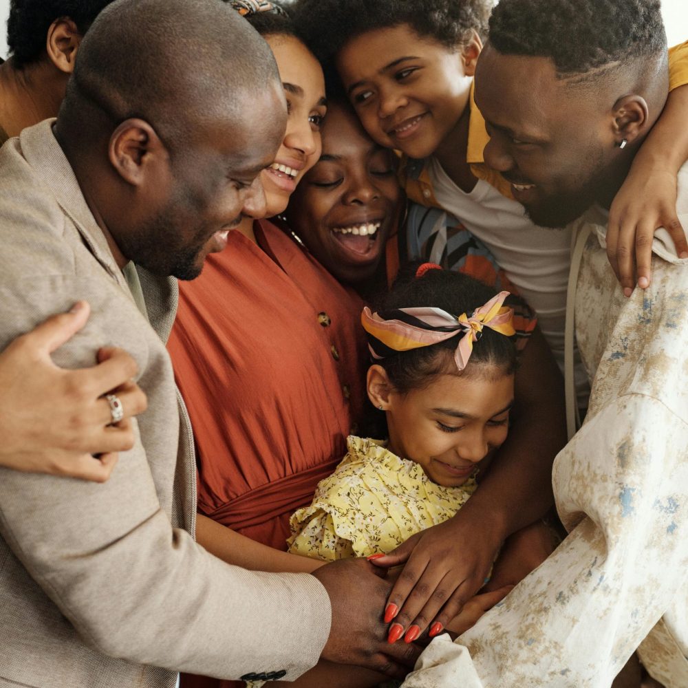 Heartwarming family group hug showcasing affection and togetherness indoors.